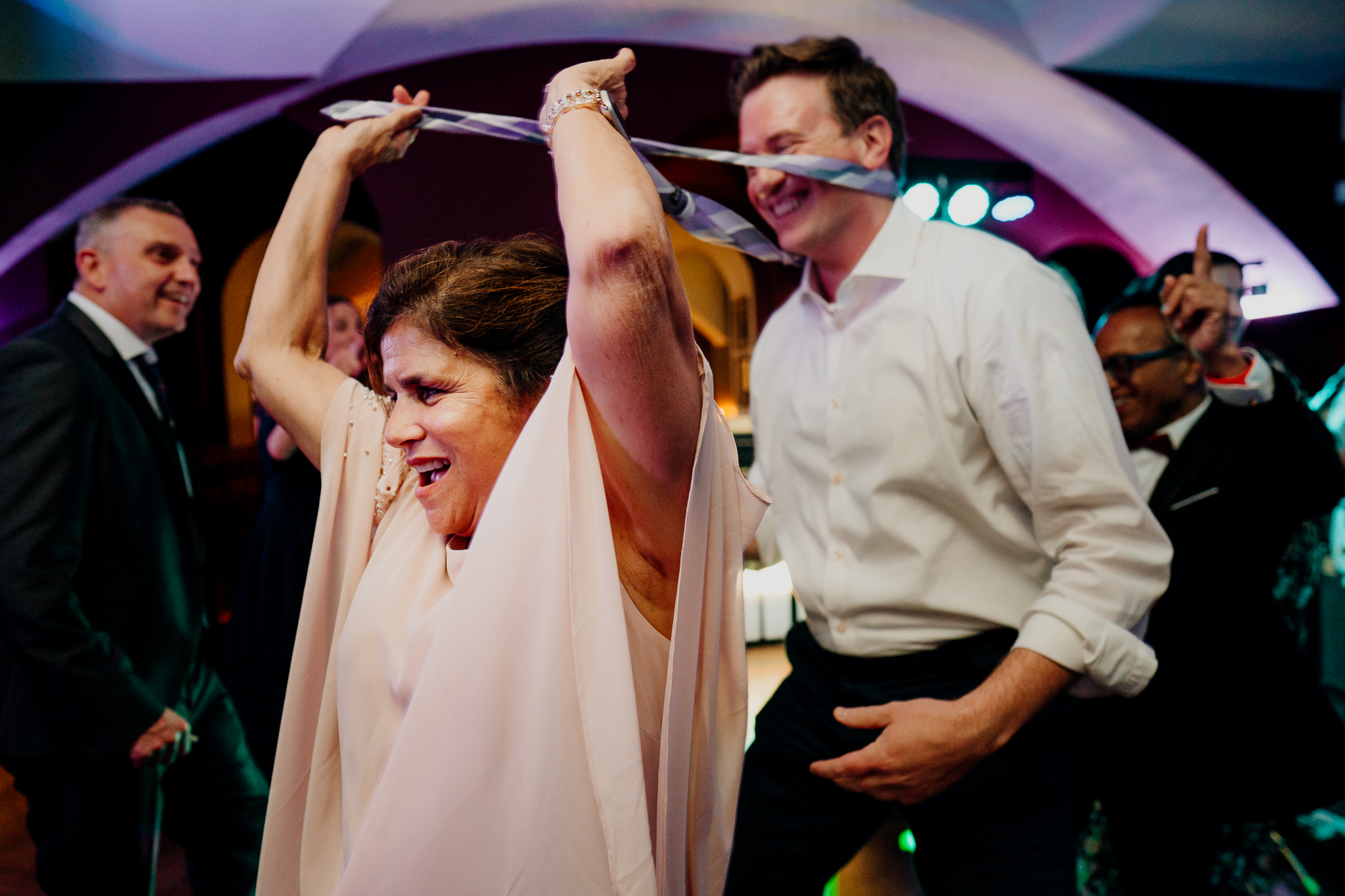 Bride dancing with her arms raised beside a male wedding guest during the evening reception at Markree Castle, County Sligo.