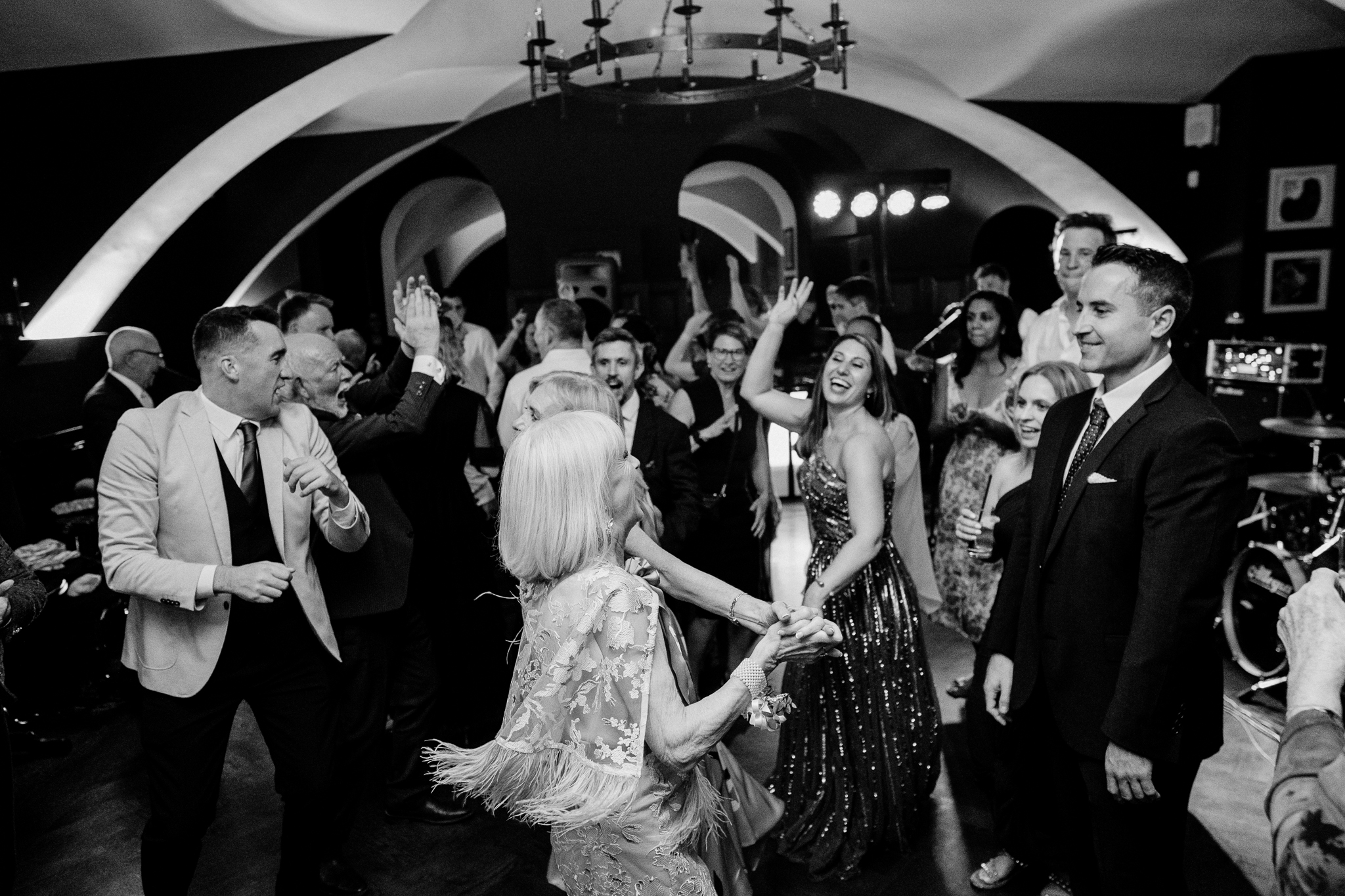 Black and white wide photograph of a crowded wedding dance floor beneath the arched ceiling at Markree Castle, County Sligo.