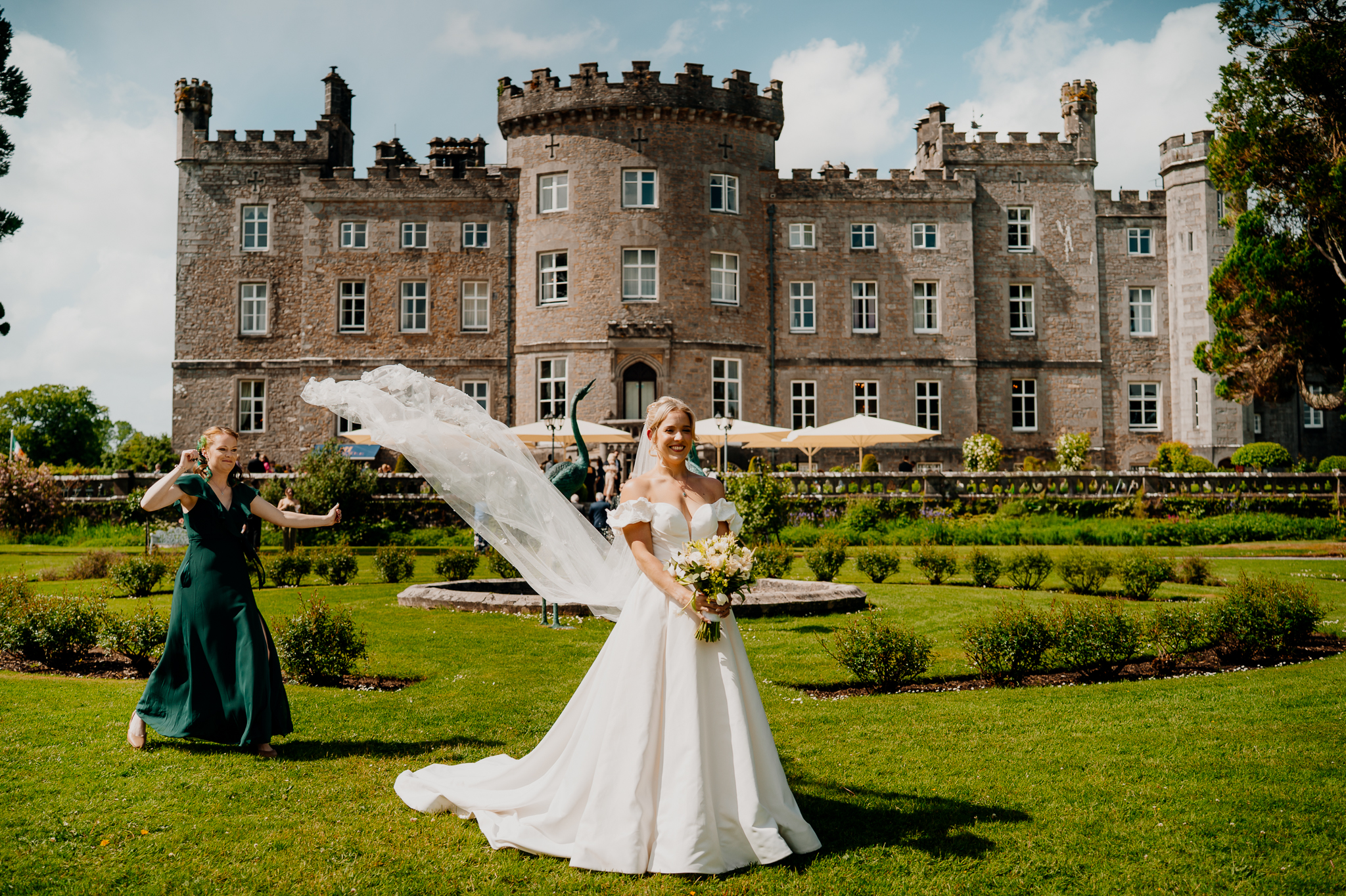 Bride in a white wedding dress with her veil flowing in the breeze in front of Markree Castle, Sligo.