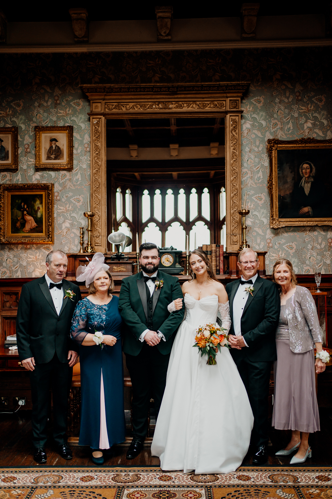 Large group of family and wedding guests posing together inside the Billiard Room at Markree Castle, Sligo.
