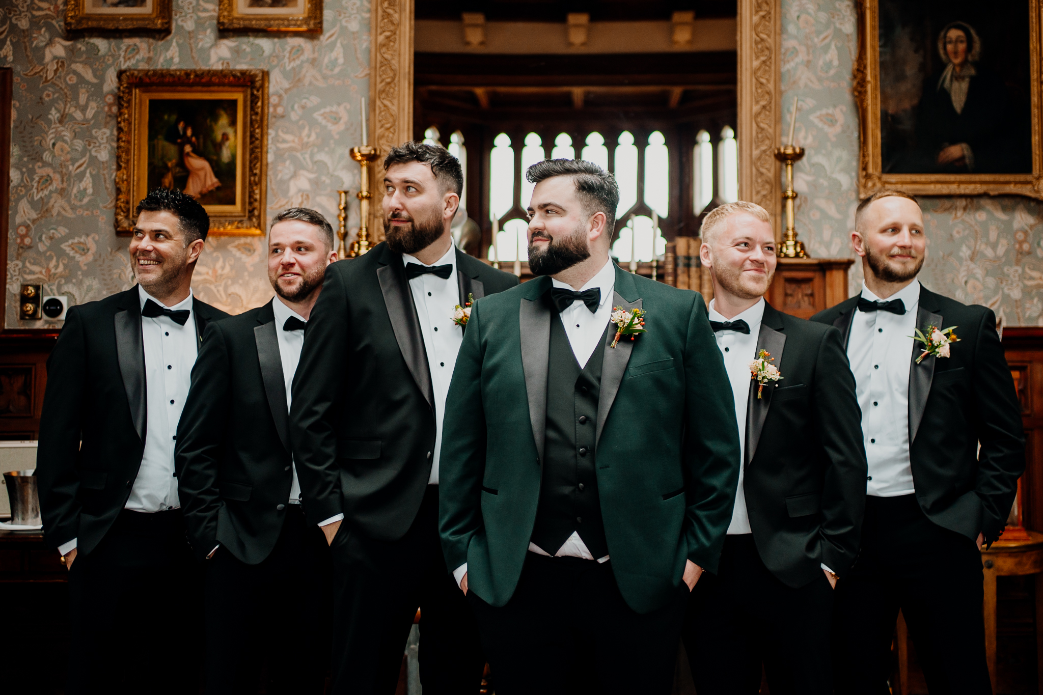 Groom Anthony posing with his groomsmen in dark green suits inside the Billiard Room at Markree Castle.
