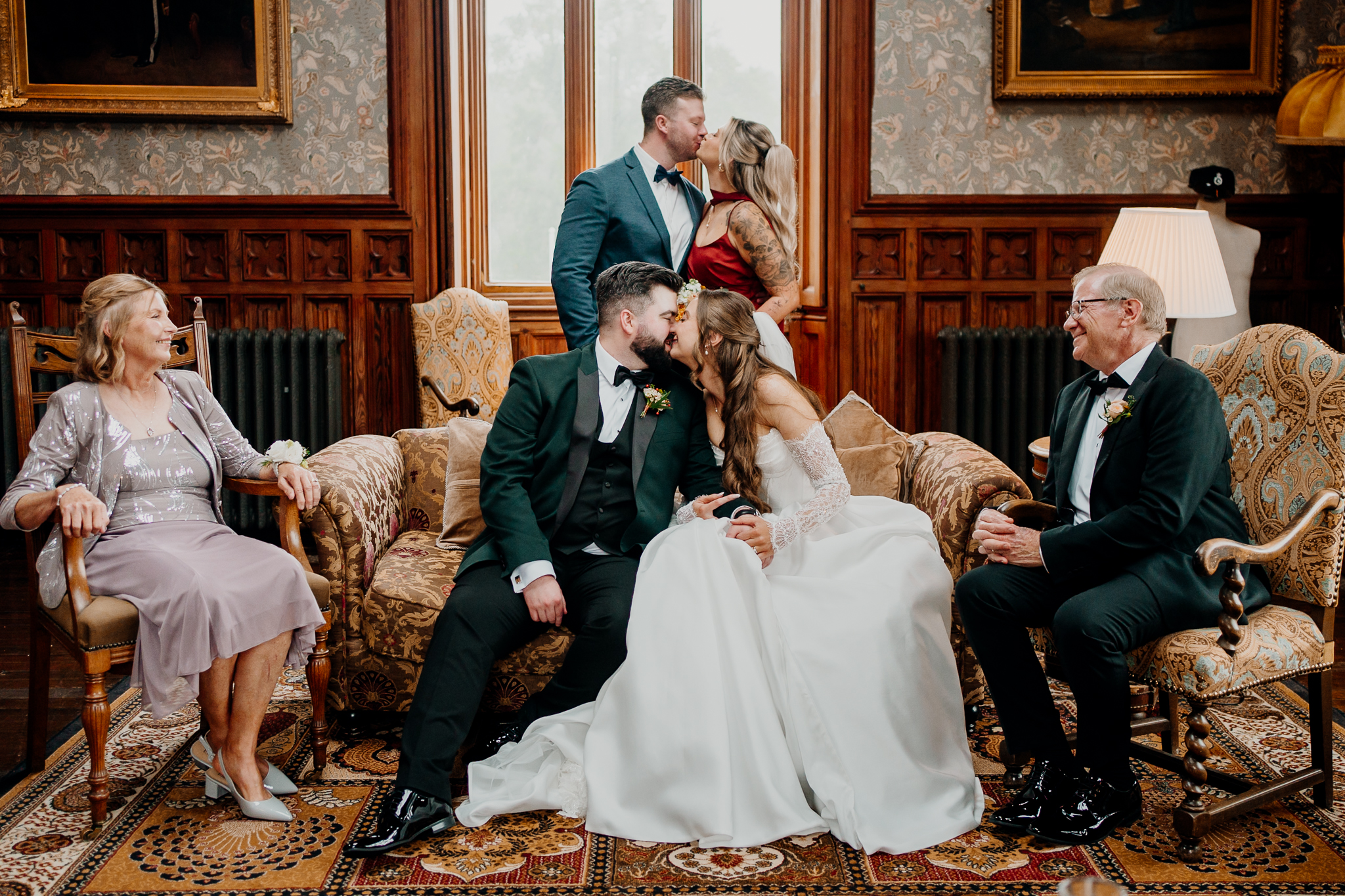 Bride and groom posing with family members for an indoor wedding portrait in Markree Castle's Billiard Room.