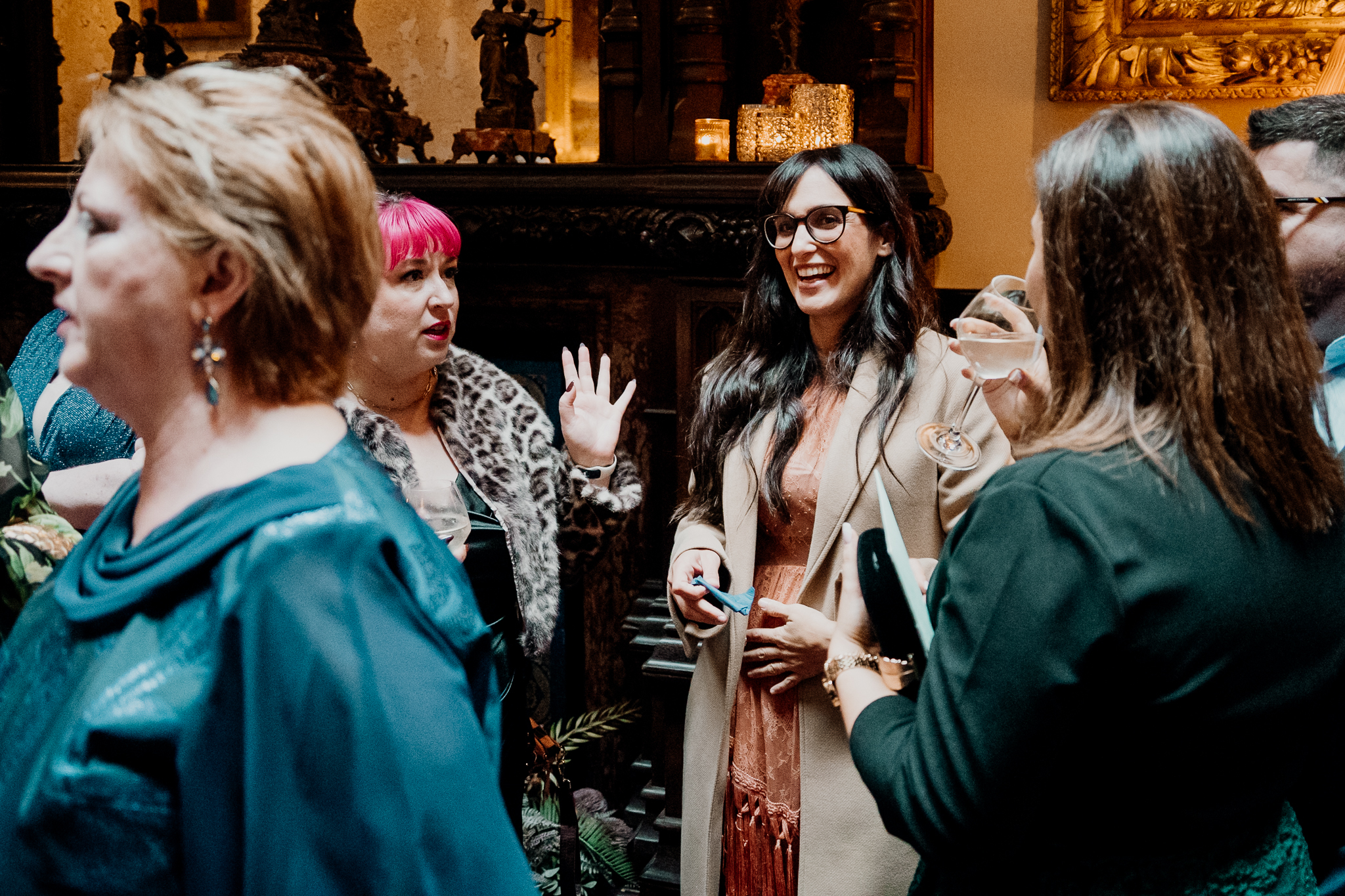 Wedding guests smiling and talking together during an indoor drinks reception at Markree Castle.