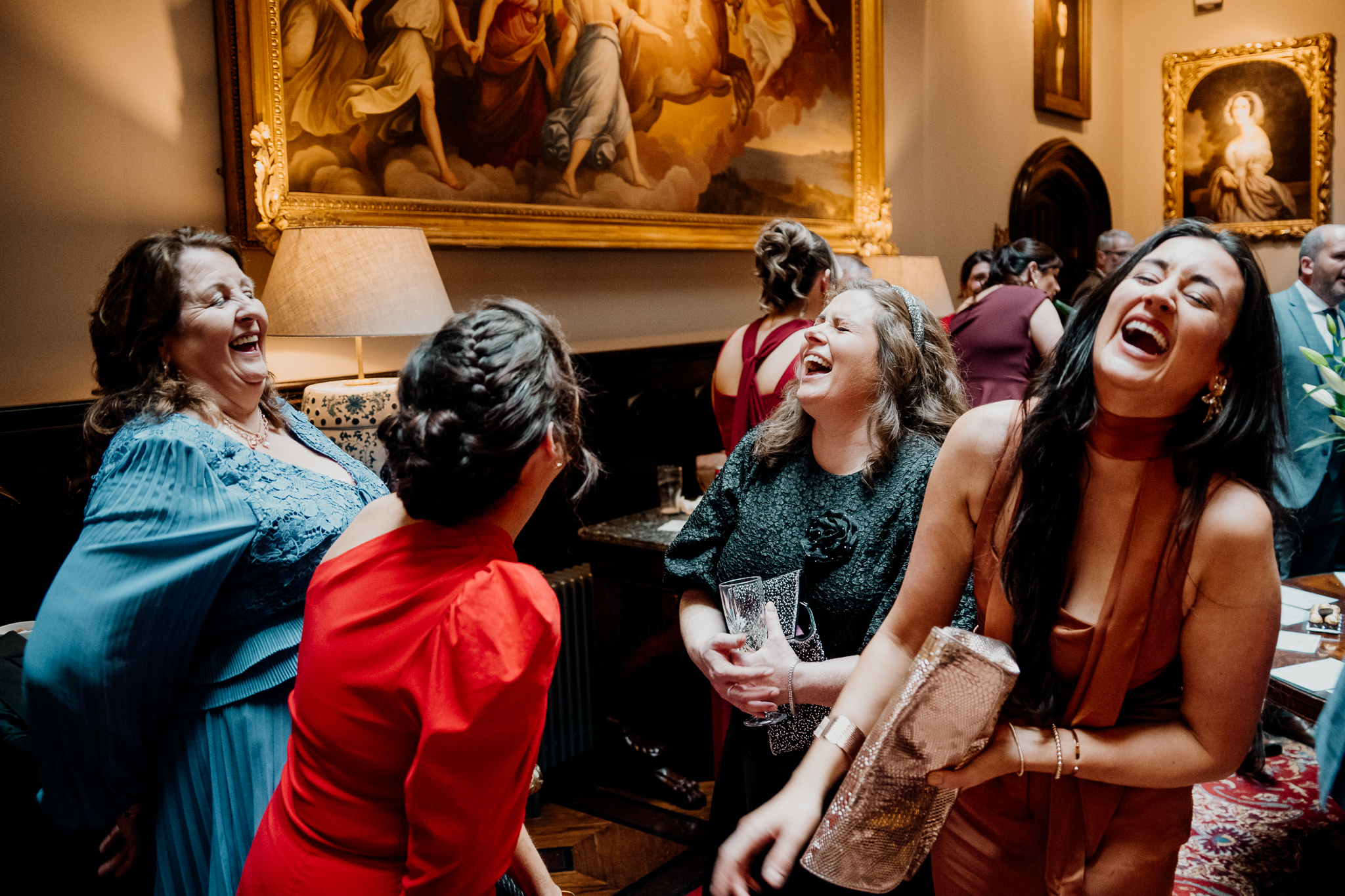 Wedding guests laughing together inside Markree Castle