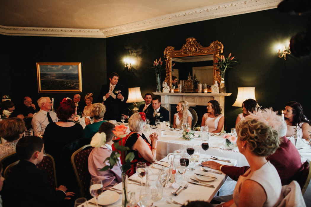 A group of people sitting at a table with wine glasses