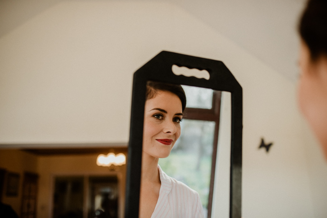 A person standing in front of a mirror posing for the camera