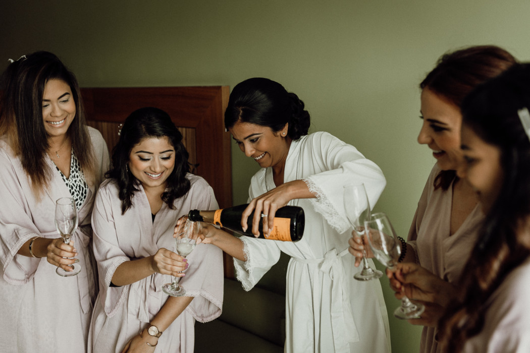 A group of people holding wine glasses
