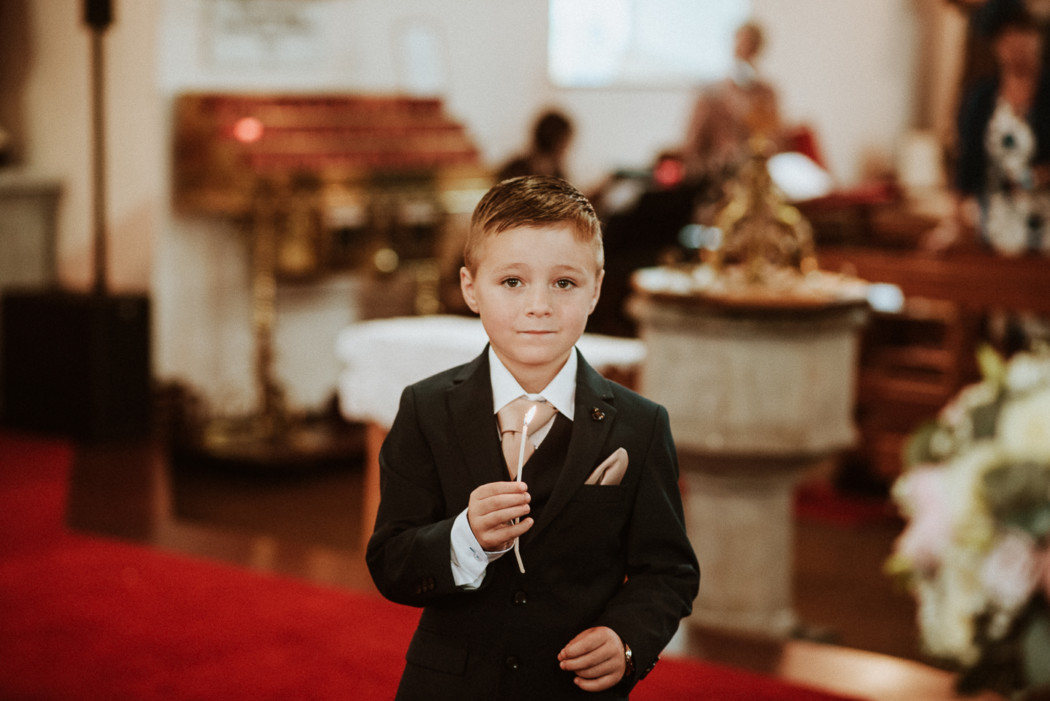 A young boy wearing a suit and tie